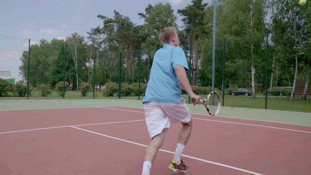 Between the legs trick tennis shot. Slow Motion.The player shows his tennis skills. This session is full of many different extremely good shots