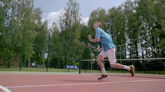 Unbelievable tennis shot. The player jumps over himself and hits the ball.The player shows his tennis skills. This session is full of many different extremely good shots