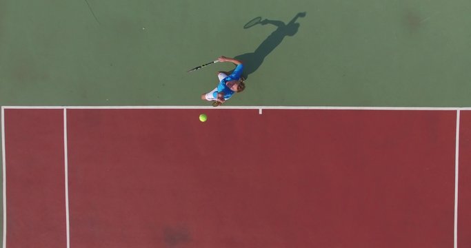 Serve with professional tennis player. Top view from the quadrocopter. 4K