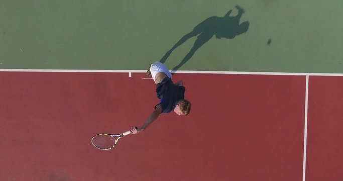 Serve with professional tennis player. Top view from the quadrocopter. 4K