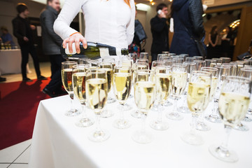 Pours champagne in glasses. Big happy holiday