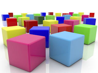 Toy cubes in various colors on white 

