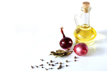 Olive oil and red onion, laurel, pepper on a white background