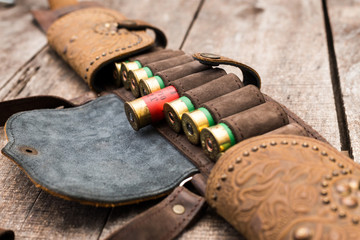 Hunter's bandolier bag on wooden background