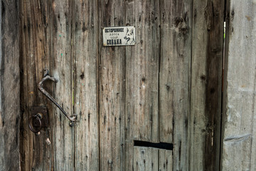 Old wooden door with wrought iron handle