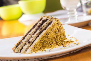 Slice of nut cake with chocolate cream