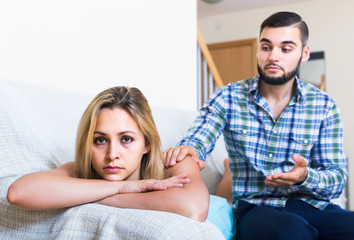 adult asking offended partner for forgiveness at home