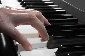 woman's hand playing the piano