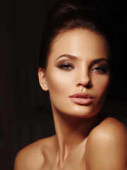 Obraz premium Elegant portrait of a sexy appealing brunette with open lips on the black background