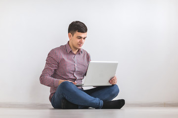 A young man working on a laptop