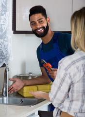 plumber and housewife in kitchen