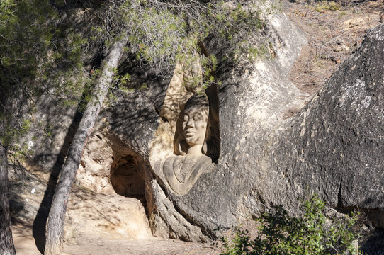 Sculptures carved on sandstones in the Ruta de las Caras, Route of the Faces, a hiking route at the shore of Buendia Reservoir, Cuenca, Spain.
