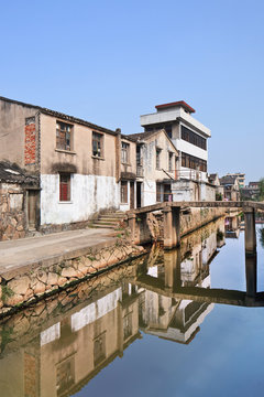 Row of traditional style houses reflected in a canal, Wenzhou, Zhejiang Province, China