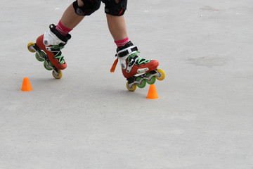 girl skating in two wheels with cones