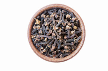 cloves in a wooden bowl isolate on a white background