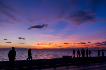 The Silhouettes are doing Activities on the Beach at Sunset