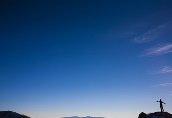 Fototapeta na wymiar The silhouette of a man in the mountains.