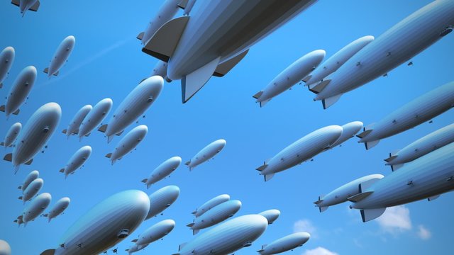 Large fleet of dirigibles. Airships are flying diagonally  across the frame.