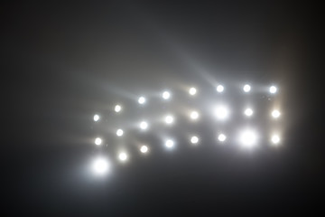 Bright white and yellow Stadium lights with fog