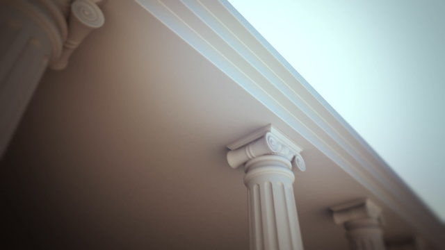 White Ionic Columns Supporting a Molded Ceiling