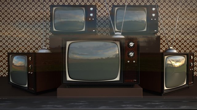 An exhibition of old-fashioned retro color tv sets with tuner antennas.