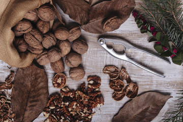 Walnuts in a pile with nutcracker