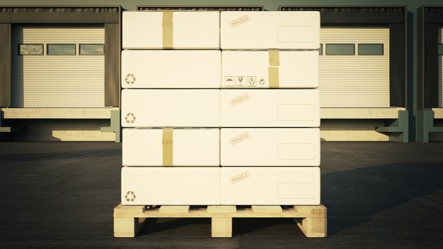 Forklift with a stack of cardboard boxes on a wooden pallet in the warehouse.