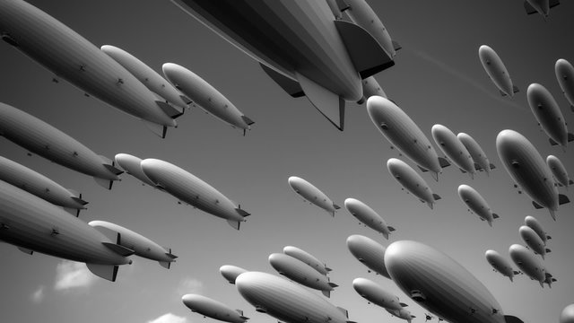Large fleet of dirigibles. Airships are flying diagonally  across the frame.