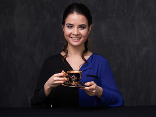  Attractive brunette keeping a cup
