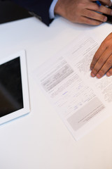Close-up Of An African Businessperson Signing Contract