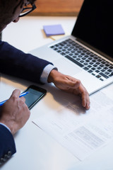 Close-up Of An African Businessperson Signing Contract