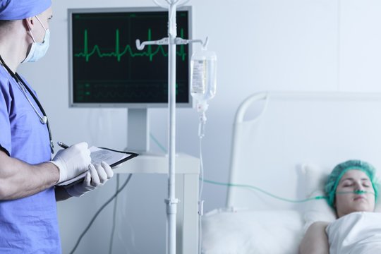 Nurse monitoring patient's vital functions