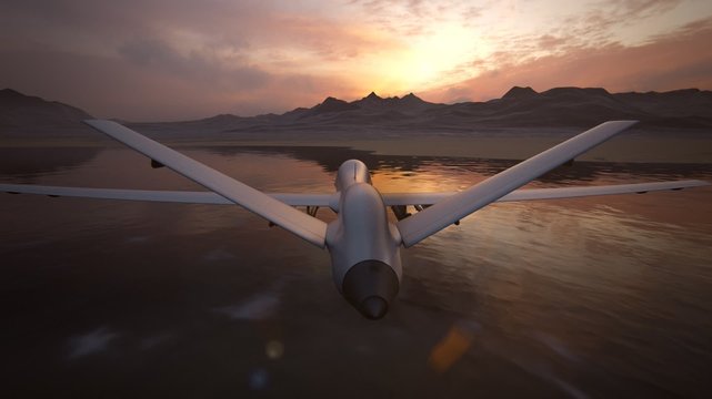 Military predator drone flying at sunset. Intelligent unmanned vehicle.