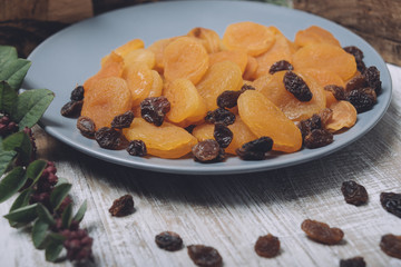 Dried apricots and raisins on a gray plate