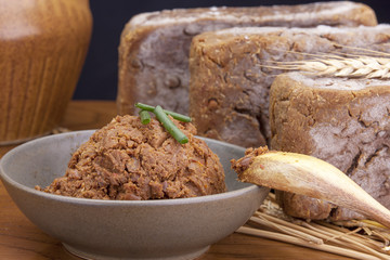 Spoon lays on bowl of Korean soy bean paste.