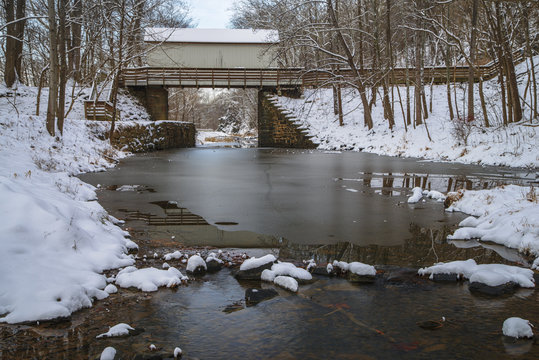 A footbridge crosses the C&O Canal on a snowy winter day.