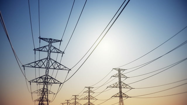 Endless electric powerlines and pylons loopable animation on a cloudless sky. HD