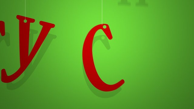Red letters on a string creating a Merry Christmas word on the green background.