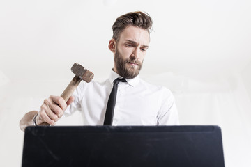 young businessman strikes hammered laptop computer © Marino Bocelli