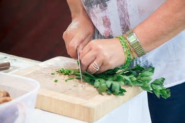 Cutting parsley on cutting board.