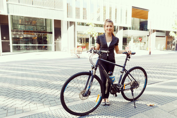 Fototapeta premium Young woman commuting on bicycle