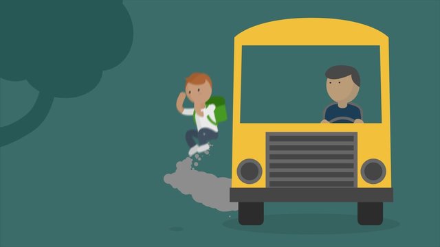 Boy with a backpack is driving by a yellow school bus. The vehicle stops.