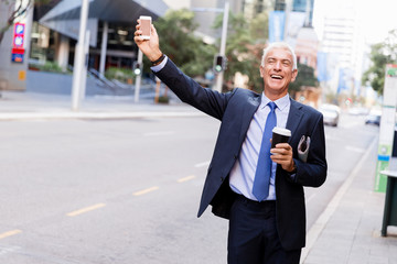 Businessman catching taxi in city