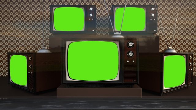 An exhibition of old-fashioned retro color tv sets with tuner antennas.