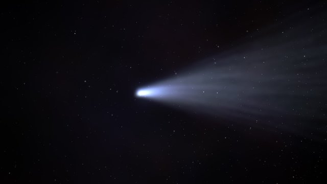 Comet flying across the night sky. This bright, ice-made celestial body.