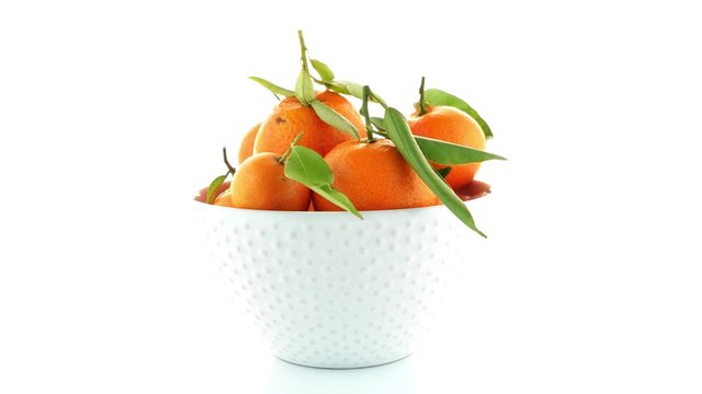 Tangerines on ceramic white bowl  isolated on white background