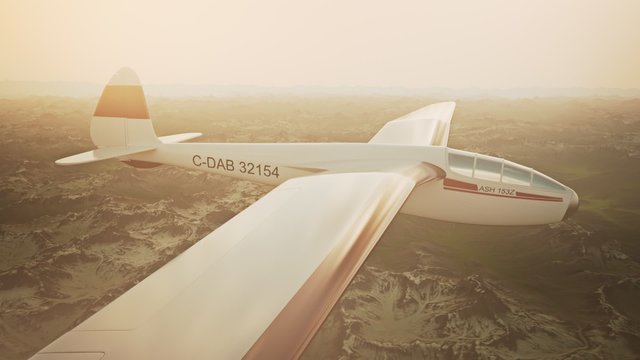 The white sailplane calmly gliding in the sky over the snow-covered mountains.