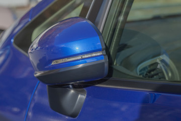 Fototapeta premium Side rear-view mirror closed for safety at car park..