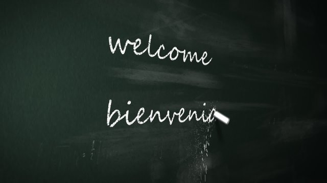 Chalk writing 'Welcome' word in multiple international foreign languages.