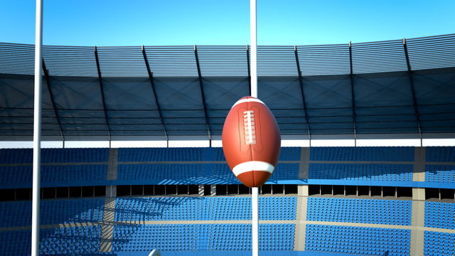 The football is tumbling in the air above the football field but missing goal.